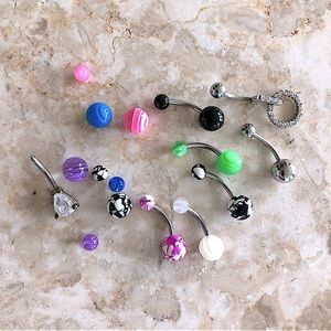 Bundle of multicolored belly button rings and extra beads
